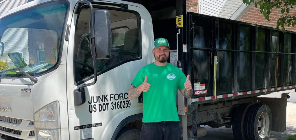Junk removal professional smiling while providing services to Palm Bay, FL
